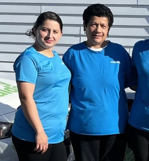 merry maids posing by branded vehicles